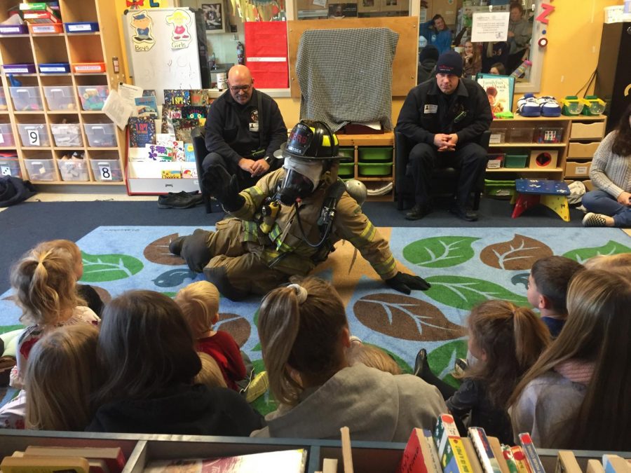 Fireman Syder dresses up to show the children what they wear.