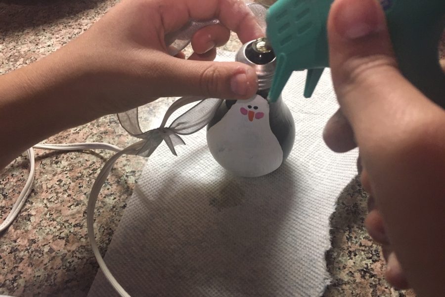 Hot glue a ribbon to the top.