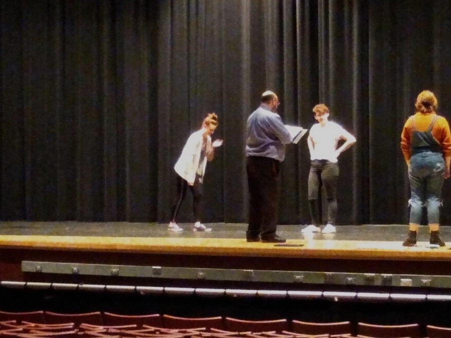 [left to right] Mr. Dan Lake assists Ashley Perise (Enchantress), Natalie Roth (Young Prince) and Beau Cameron (Student Director) with the prologue