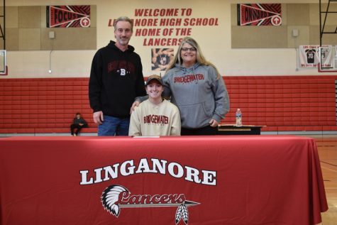 Sam Everett poses with family after officially signing to play softball for Bridgewater college.