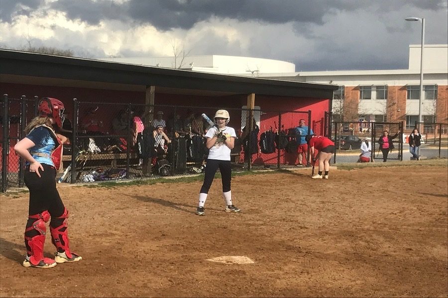 Class of 2021 member Darbe Reesman steps up to the plate to practice hitting in a game situation while class of 2021 member Alex Dembeck practices catching.