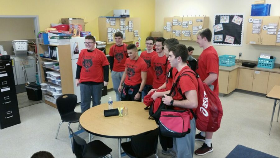 Jimmy and the team wear their new shirts before departing for the state match.