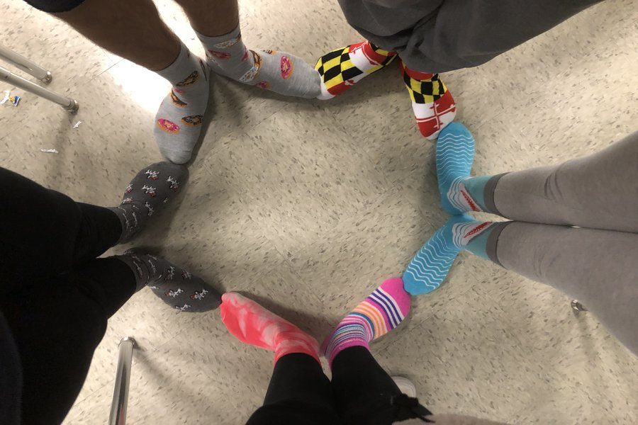 Class of 2021 students, Bailey Bennett, Leah Bolger, Matilda Geffen, Ashley Nash and Julian Rodriguez show off their socks to celebrate World Down Syndrome Day.