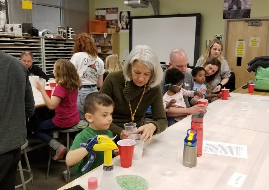 Principal Nancy Doll helps elementary school students make slime with NEHS. 