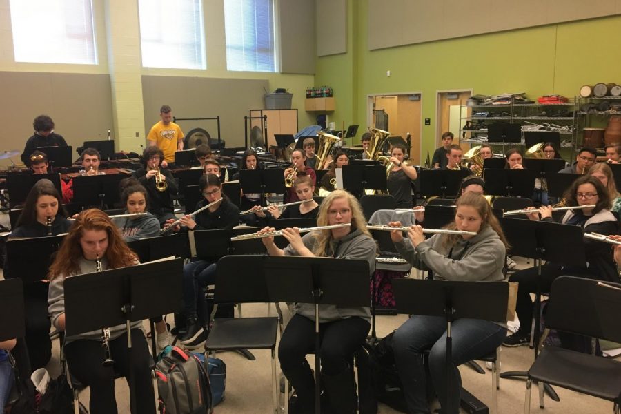 Symphonic band students play scales as they warm up for a long practice.