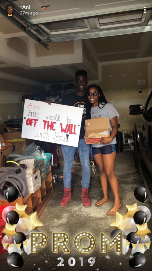 Kojo Benefo and Ave-Boghossian James posing for a cute picture with their unique promposal sign. 