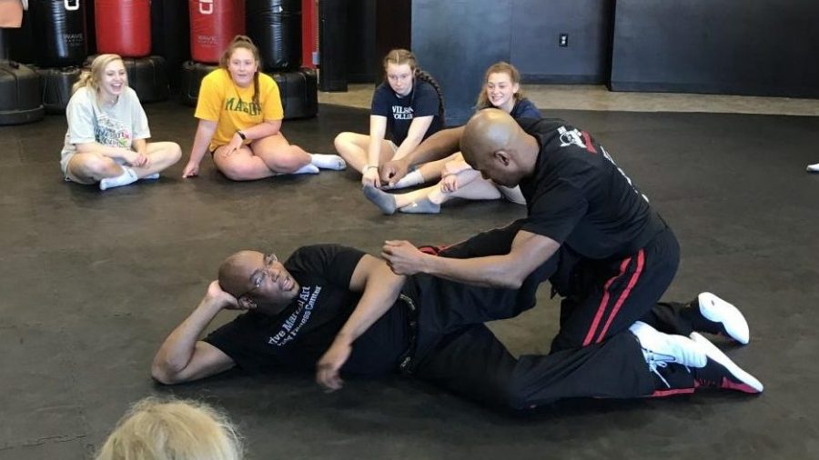 Strive instructors Derek Watson and Anthony Lewis demonstrate self-defense tactics. 