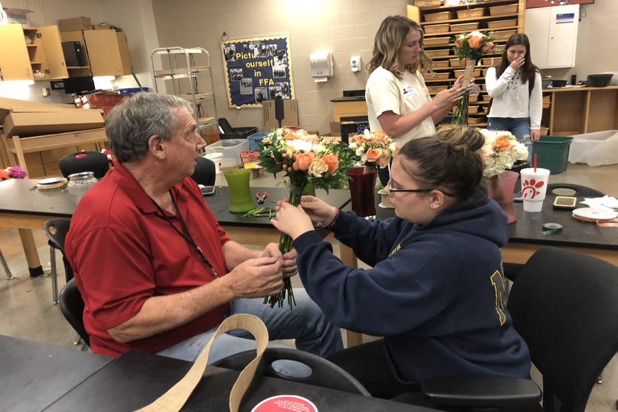 Mr. Hawthorne helps Lacee Larman arrange a bouquet for Saturdays wedding.