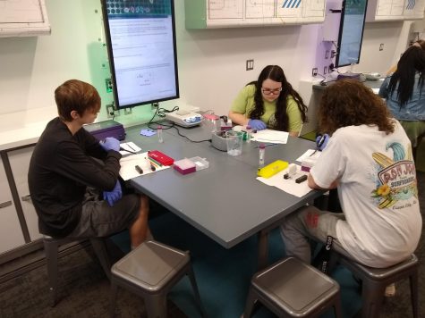 Zack Olliges, Elizabeth Gilmore and Joseph Hartung test DNA samples in the mobile lab.