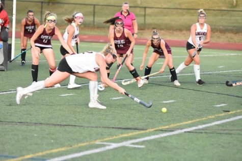 Senior attacker Olivia Giesler looks to pass the ball to teammates Kayla Freeman or Carmen Wilhelm.