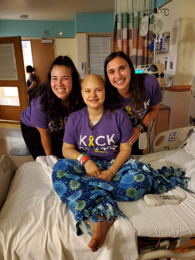 Frederick High School student Danielle Hankey poses with two of her favorite nurses sporting her "Kick Cancers Butt" t-shirt.