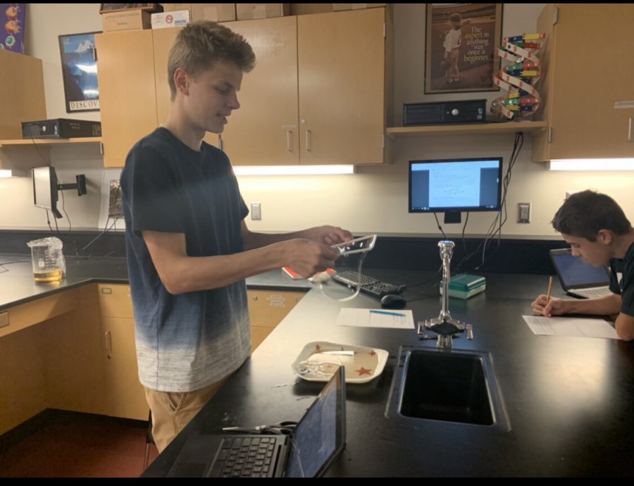 Students Ryan Miller and Andrew Lyons work on their bubble cell membrane lab. 