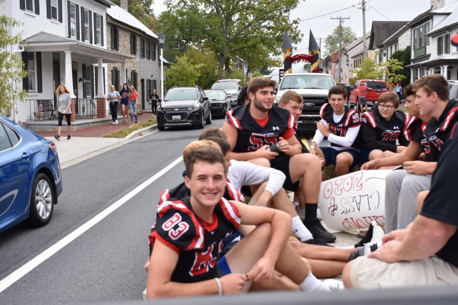 Saturday: Senior Billy Higgins and varsity football players ride in the parade through New Market. This was the first year they participated. They had won against Oakdale the night before and would go on to win the homecoming game against Walkersville 17-0.
