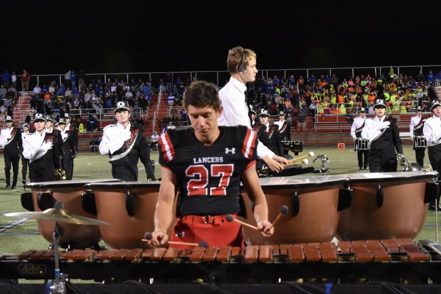 Football player Ethan Blache plays the marimba during the bands half-time performance.