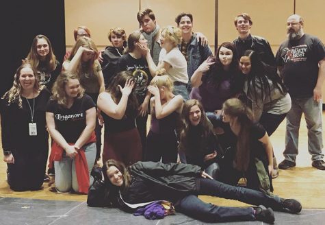Drama students pose onstage after a day of doing workshops