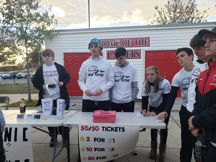 Tabitha Knediesen sells raffle tickets with help from classmates in the Management and Entrepreneurship class.