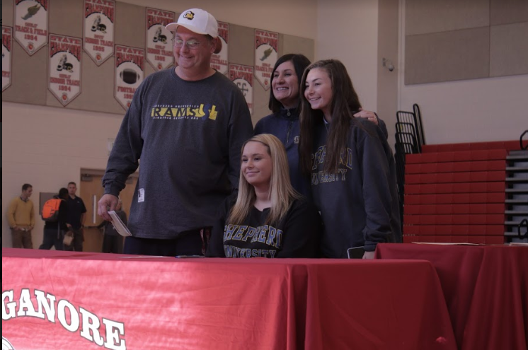 Ellie poses with family after signing her National Letter of Intent.