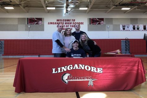 Braden Weinel poses with his family after officially signing to Hood College.