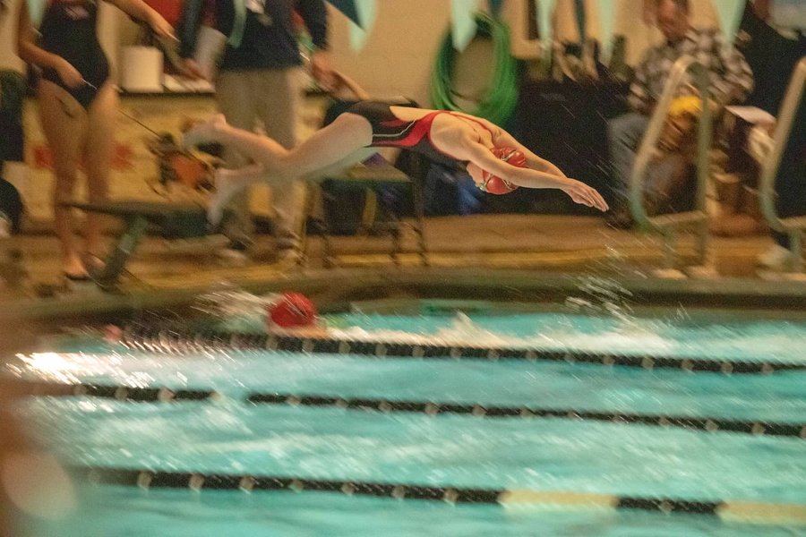 Kelly Safsten dives into the first meet of the season.