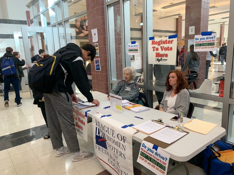 Students register to vote at the Frederick County Government board of elections table.  