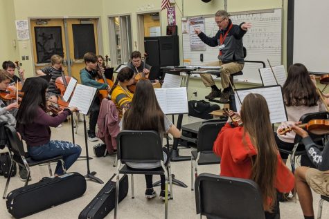 Mr. Dye conducts the orchestra through their warm-up piece, Fiddle OFinnigan. 