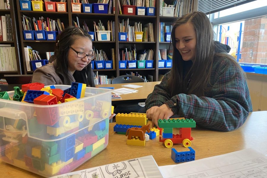 Valerie Ducos and Chloe Bremer play with Mega Blocks. 