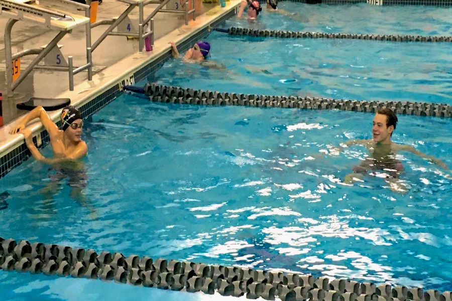 Swimmers Neilson Parrott (left) and Gabriel Erb (right) maintain a social distance in the water.  