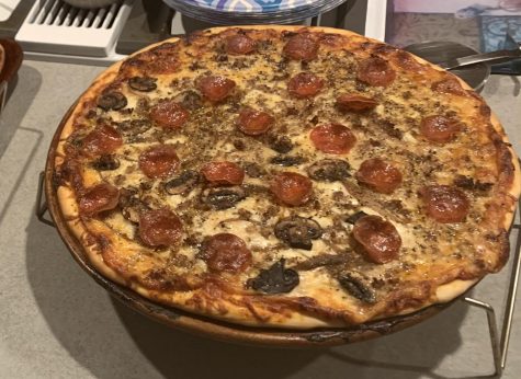  The perfect homemade pizza out of the oven with pepperoni, bacon, sausage, and mushrooms