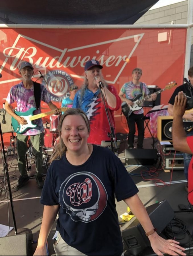 Beth Ericsson posing in front of her Husbandss band st National Park, on Grateful Dead Night.