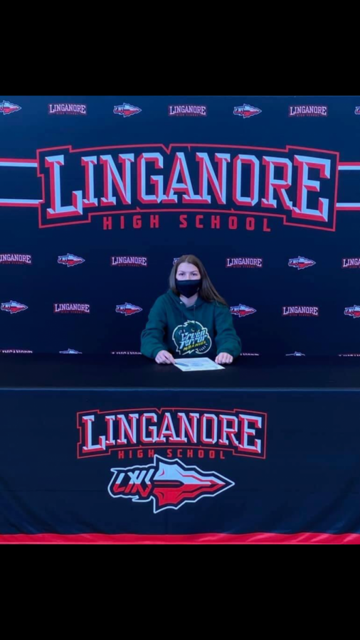 Hill signing her National Letter of Intent to play Division II soccer at McDaniel College. 