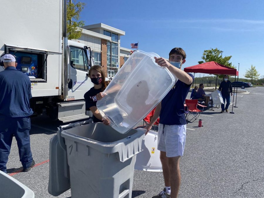 Senior officers, Jake Orlando and Ashley Nash, help out at the event by collecting papers to be shredded.