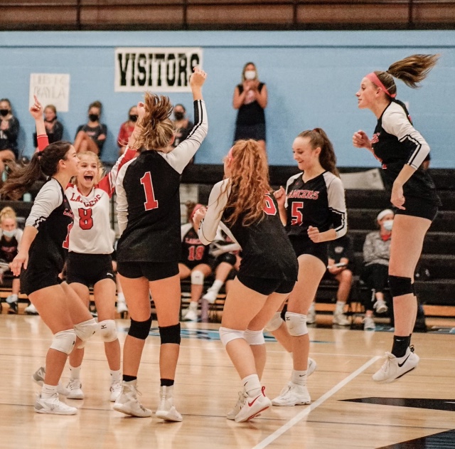 The varsity volleyball team celebrates a point earned during the game.  The opponent was Westminster High.