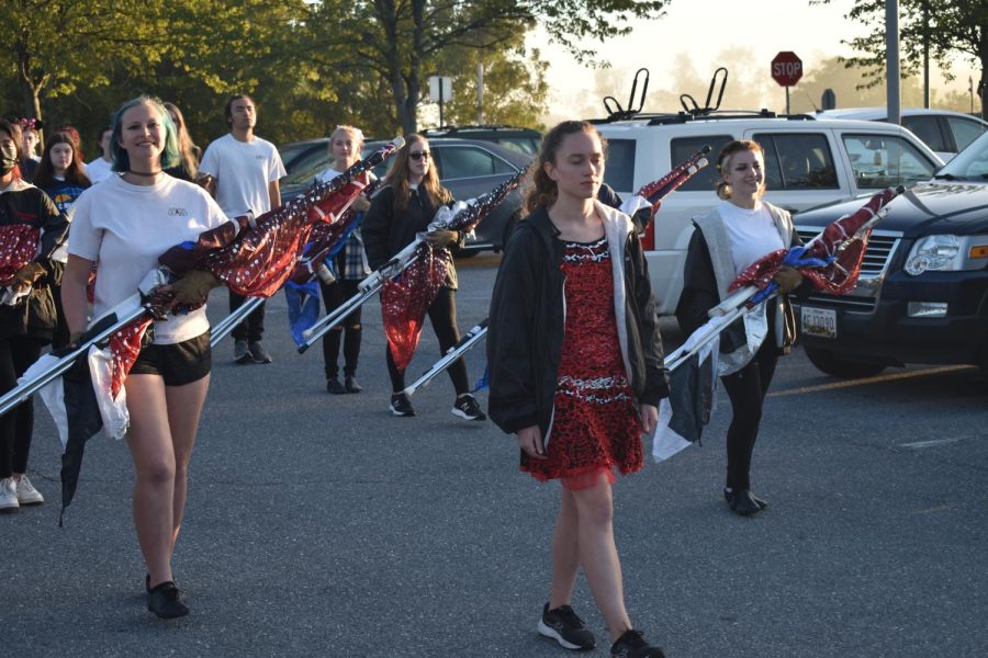 Emily Watson leads marching band towards the stadium, getting ready for the pep rally.