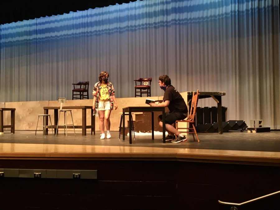 Julia Hersch (playing Arthur Roeder) and Joseph Looper (playing Dr. Von Sochocky) taking center stage while performing a scene from the first act of Radium Girls.
