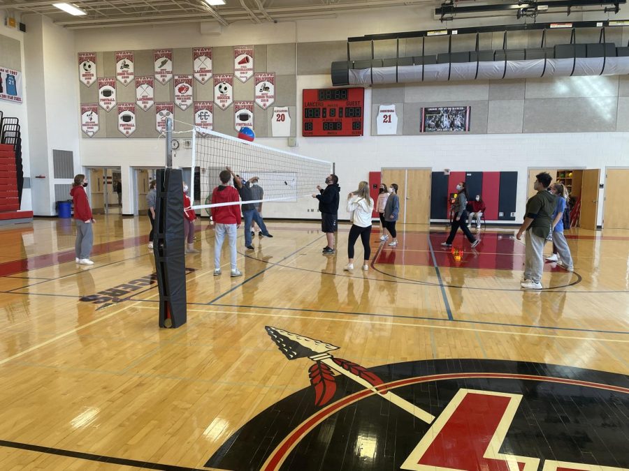 This is the 2nd lunch gym class where there are a few students playing volleyball.