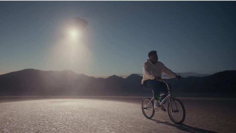 Baby Keem rides a bike in the middle of a desert during the Issues music video.