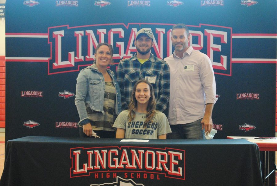 Josie and her family pose for a picture after officially becoming a Ram.