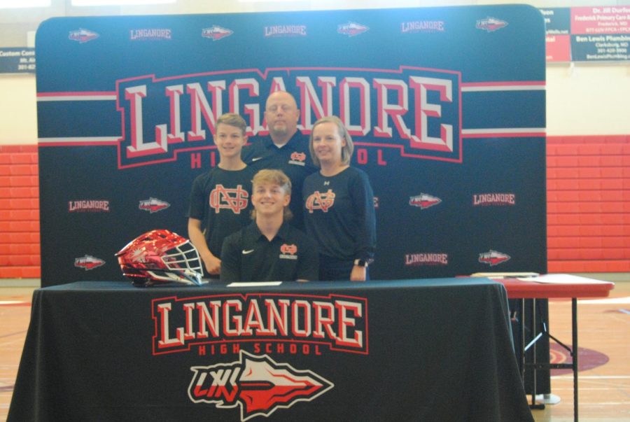 Sean Mullineaux and his family pose for a picture after signing his letter of intent to commit to play lacrosse at NGU.