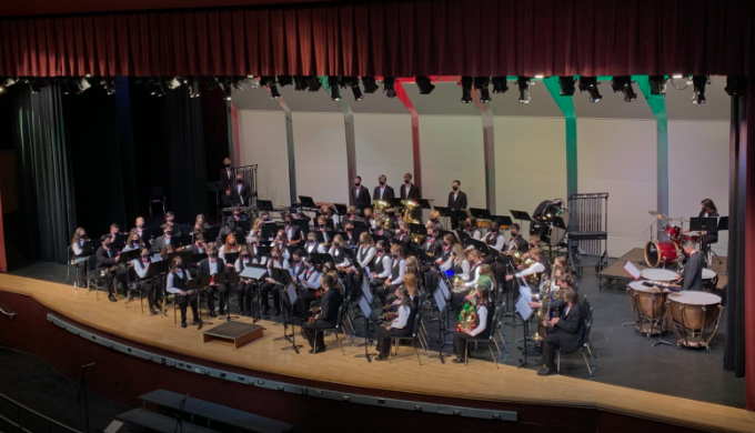 The concert band prepares to play their first piece.
