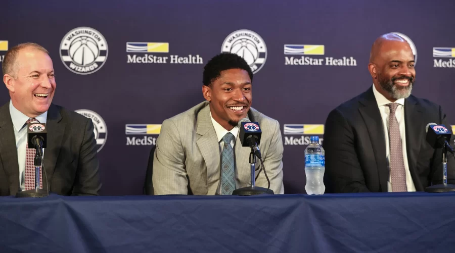 Bradley Beal(left) celebrates his contract extension with Ted Leonois(Left) and Wes Unseld Jr(Right).