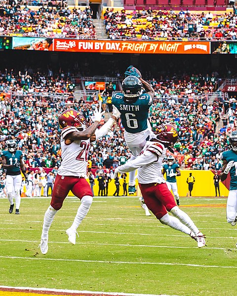 Devonta Smith with the ball into his hands and securing the catch.