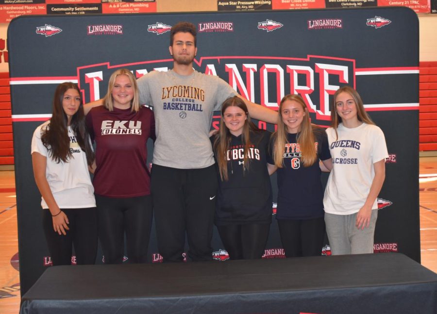 Senior athletes gather for photos after signing their National Letters of Intent. 