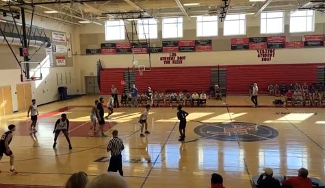 Boys Varsity Basketball prepares to play defense against Winston Churchill High School. 