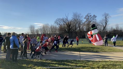 Participants in the 11th Annual Egg Nog Jog line up at the start line to begin the race.