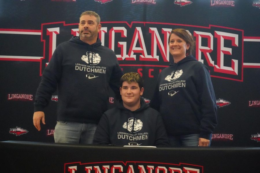 Logan Bernstein and his family pose for pictures after he signs his Letter of Intent to play football for Lebanon Valley College.