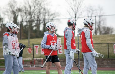 Members of the Linganore boys varsity lacrosse team prepare for the first game of the season.