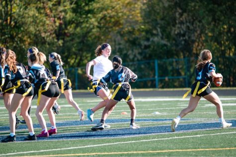 Girls recreational flag football team player Grace Meyer runs the ball for Oakdale. 