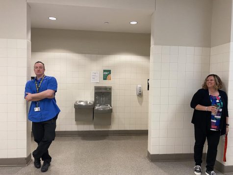 Aaron Burch and Lynn Fox fulfilling their duty of guarding the restroom doors in the minutes prior to the start of classes.
