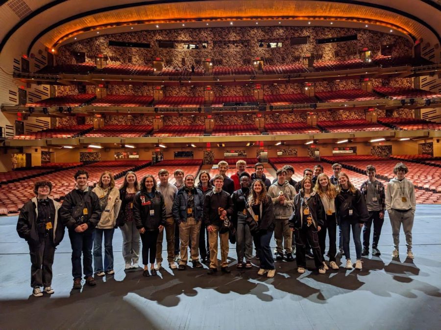 A group of students in the band pose on the stage of Radio City Music Hall. This was a special opportunity for the band students, as usually only performers get to stand on the stage.