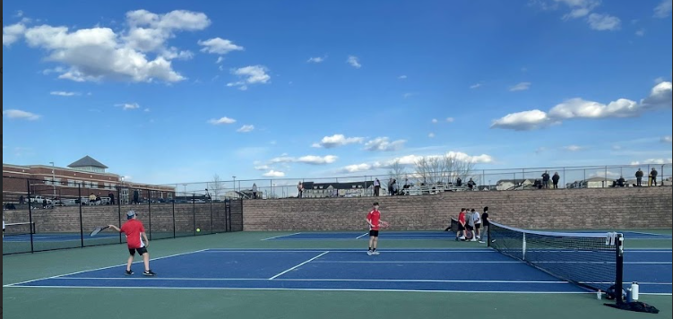 Doubles players Jack LauterBach and Jack Winkler with a great shot against the Oakdale Bears